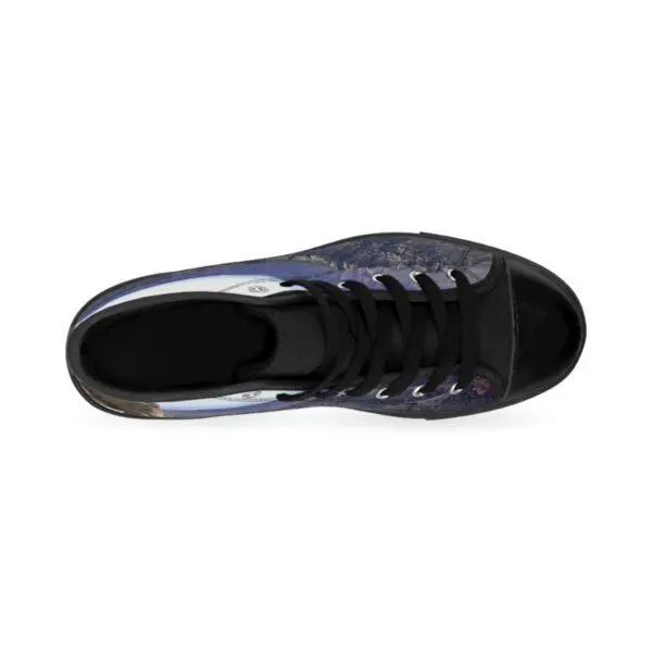 A top view of the shoe with black and blue laces.