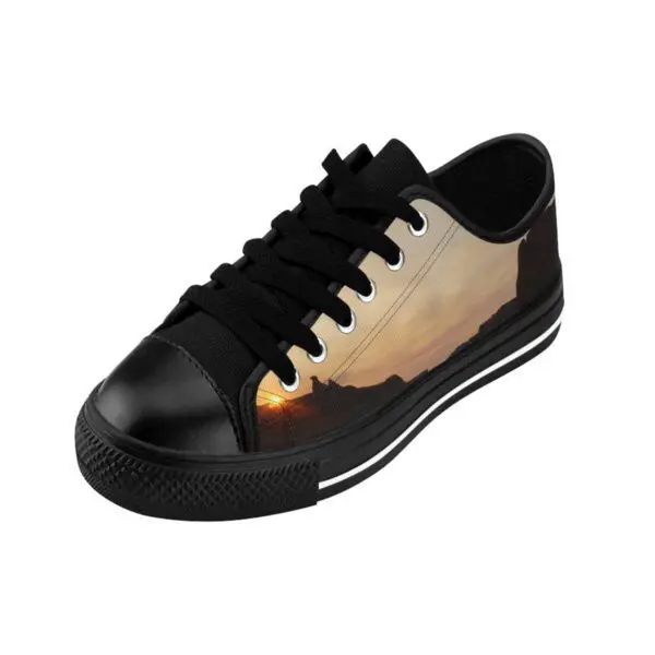 A black and white shoe with a picture of the sun.