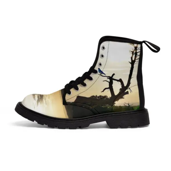 A pair of boots with trees and birds on them.