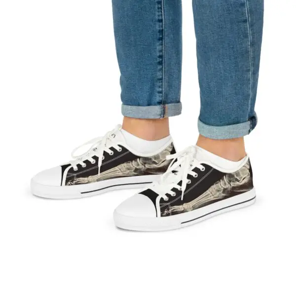 A person wearing black and white shoes with their feet up.