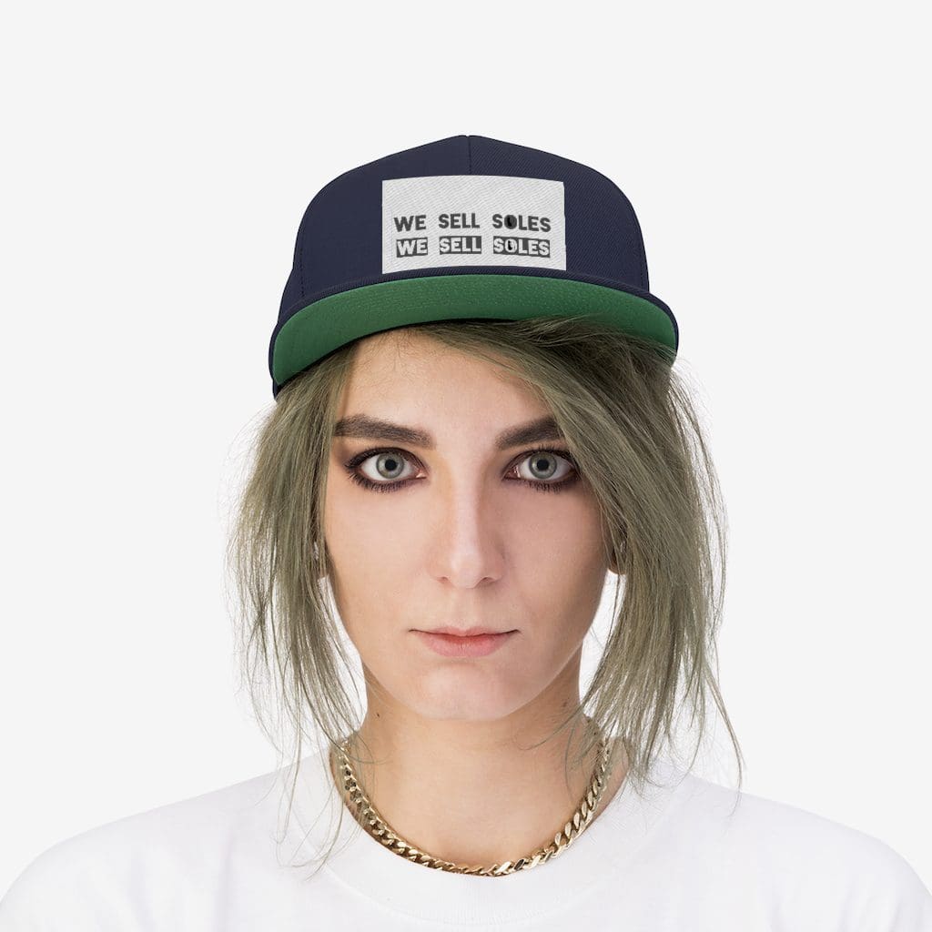 Person wearing navy We Sell Soles cap