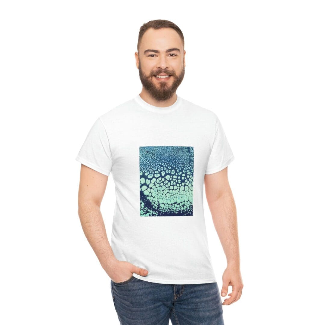 Smiling man in white tee with teal print
