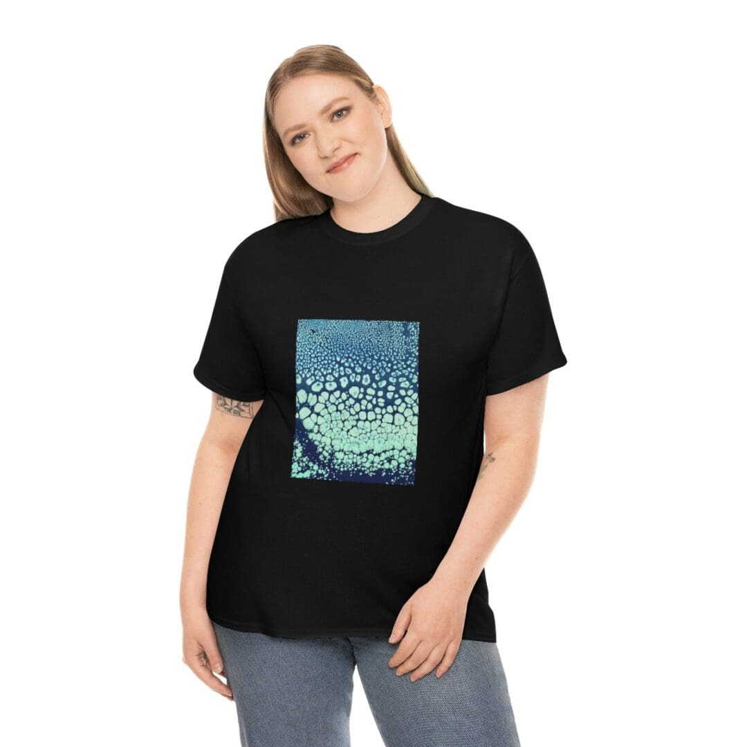 Smiling model in black tee with teal print