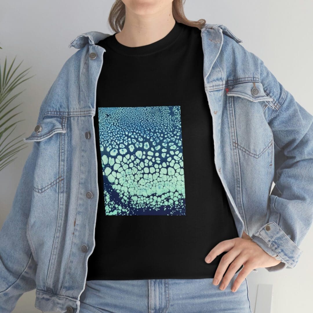Denim jacket over black tee with teal print