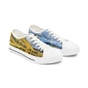 Pair of white sneakers with fall landscape
