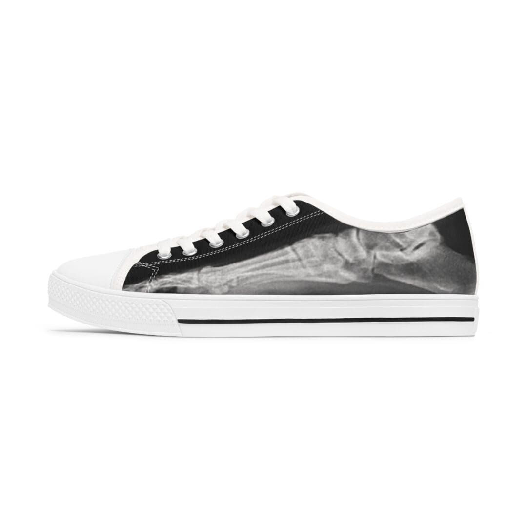 A pair of black and white sneakers on top of a white surface.
